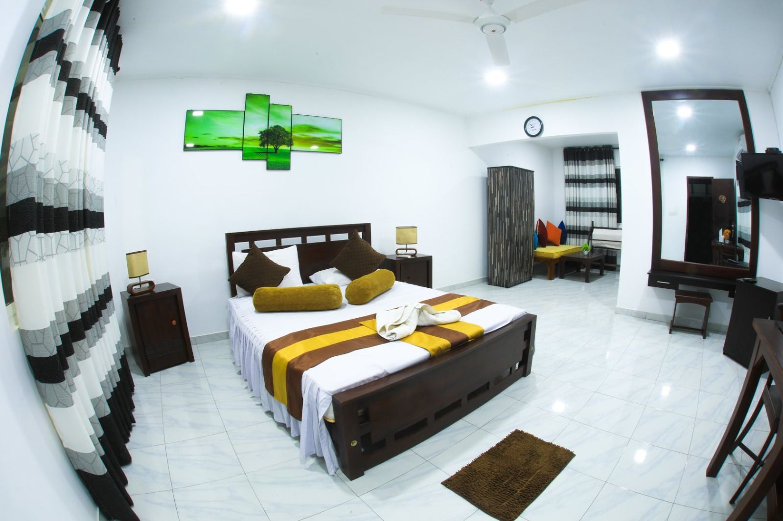 Deluxe room with white tiles and a large double bed
