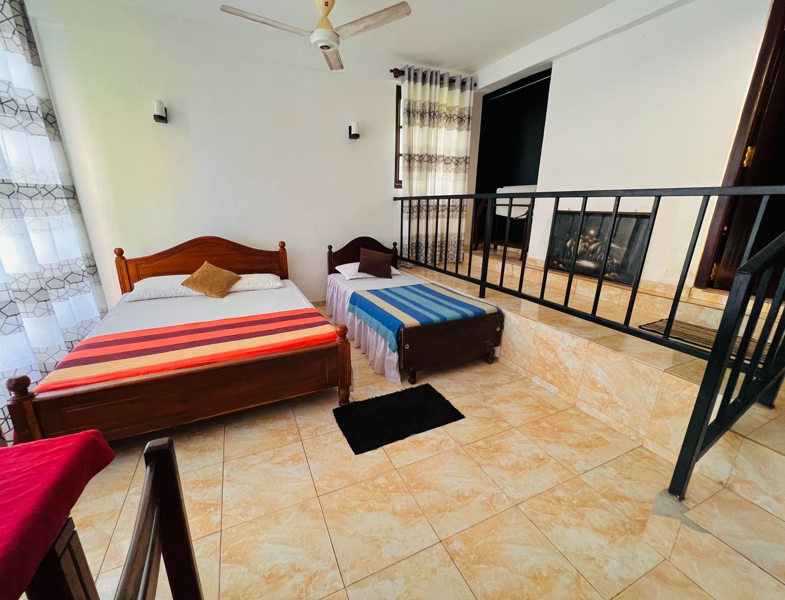Split-level family room with beds on a raised floor